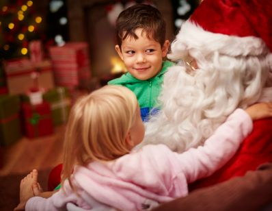 two kids sitting on Santa's lap