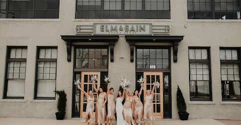 bridal party in front of building 
