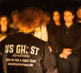 the back of the tour guide's shirt with all the information for the ghost tour