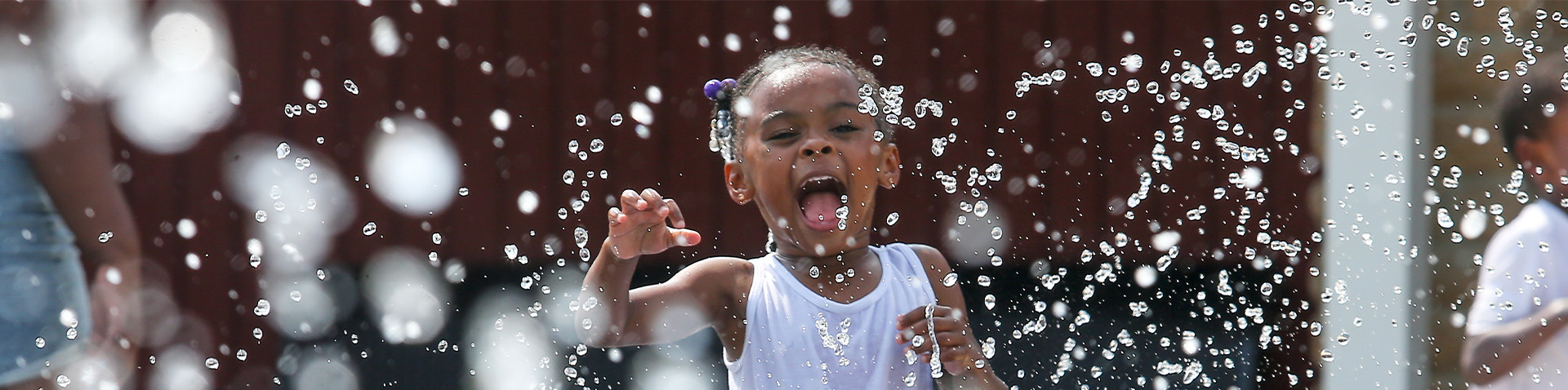 a little girl having fun in the splash pad