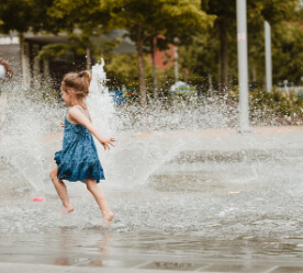 girl playing in fountain
