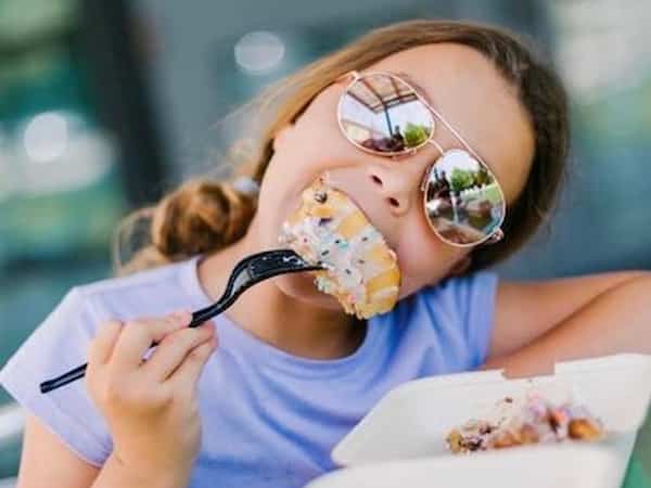 a little girl eating dessert