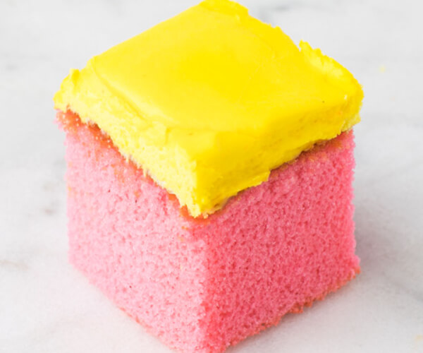 pink cake with yellow frosting