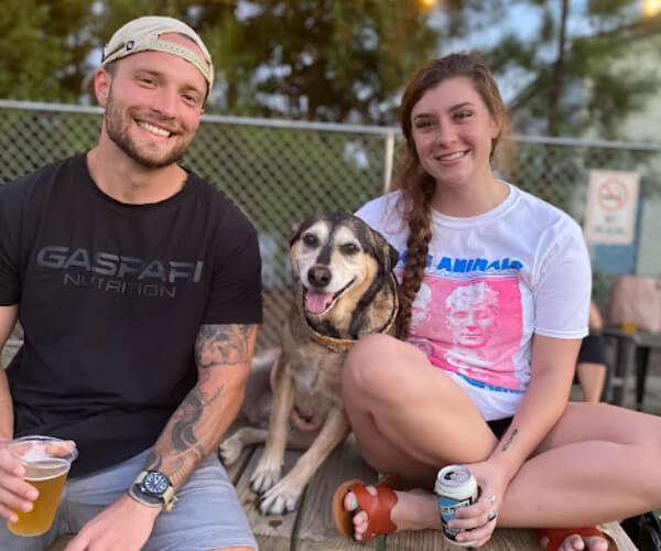 couple with a dog and drinks