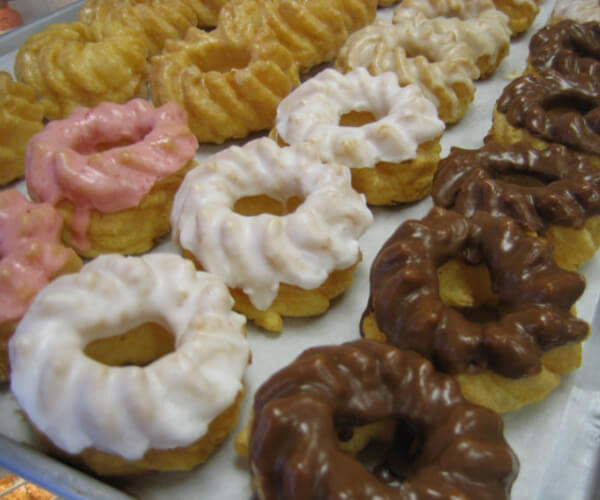 an assortment of donuts in the display