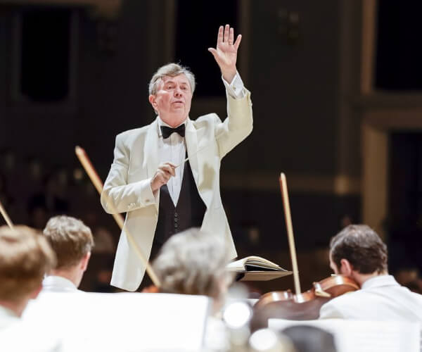 conductor in a white suit