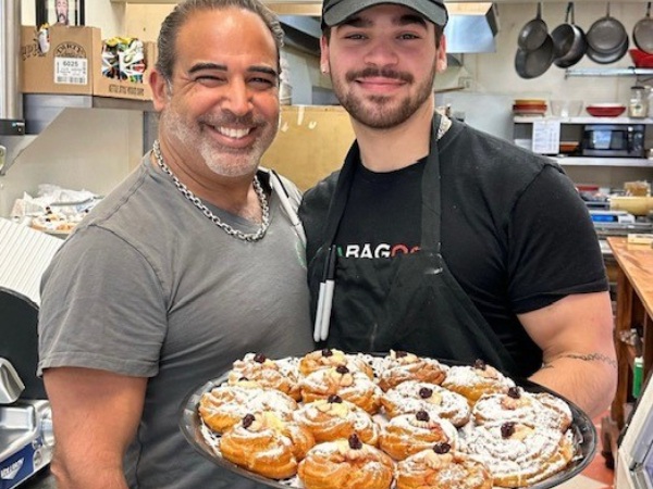 men posing with pastries
