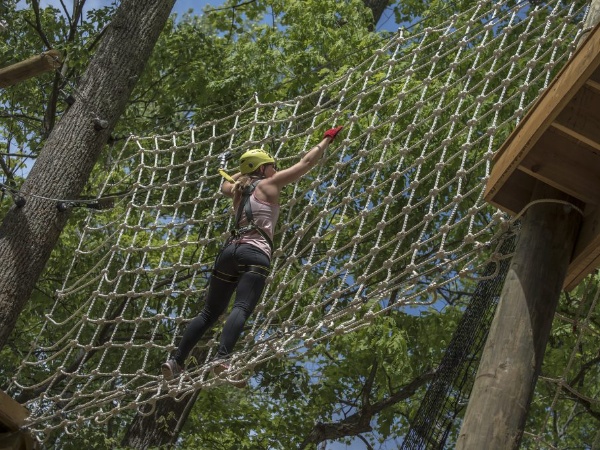 Woman climbing on net