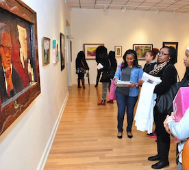 students looking at painting in gallery
