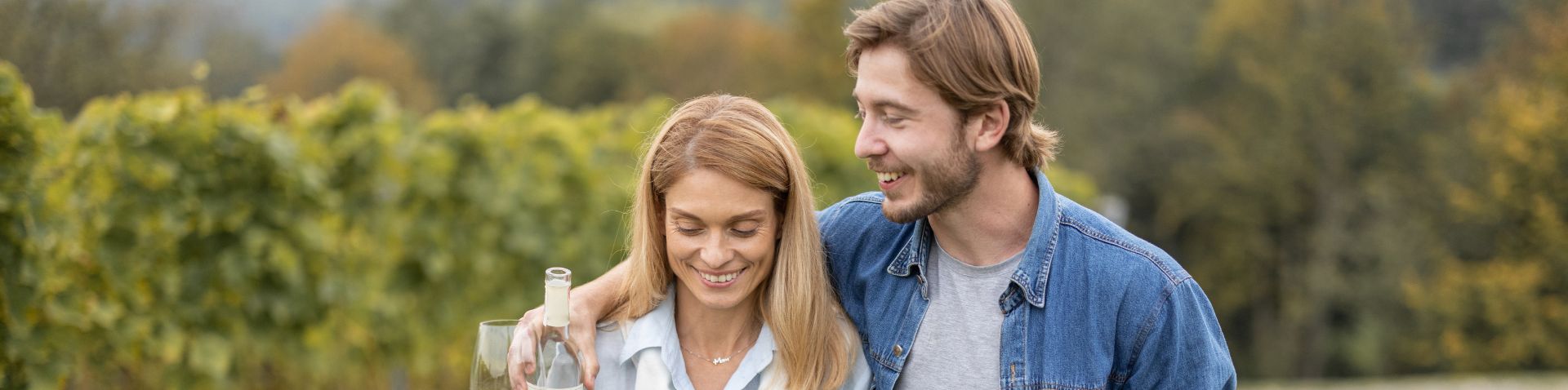 a couple walking in a vineyard together