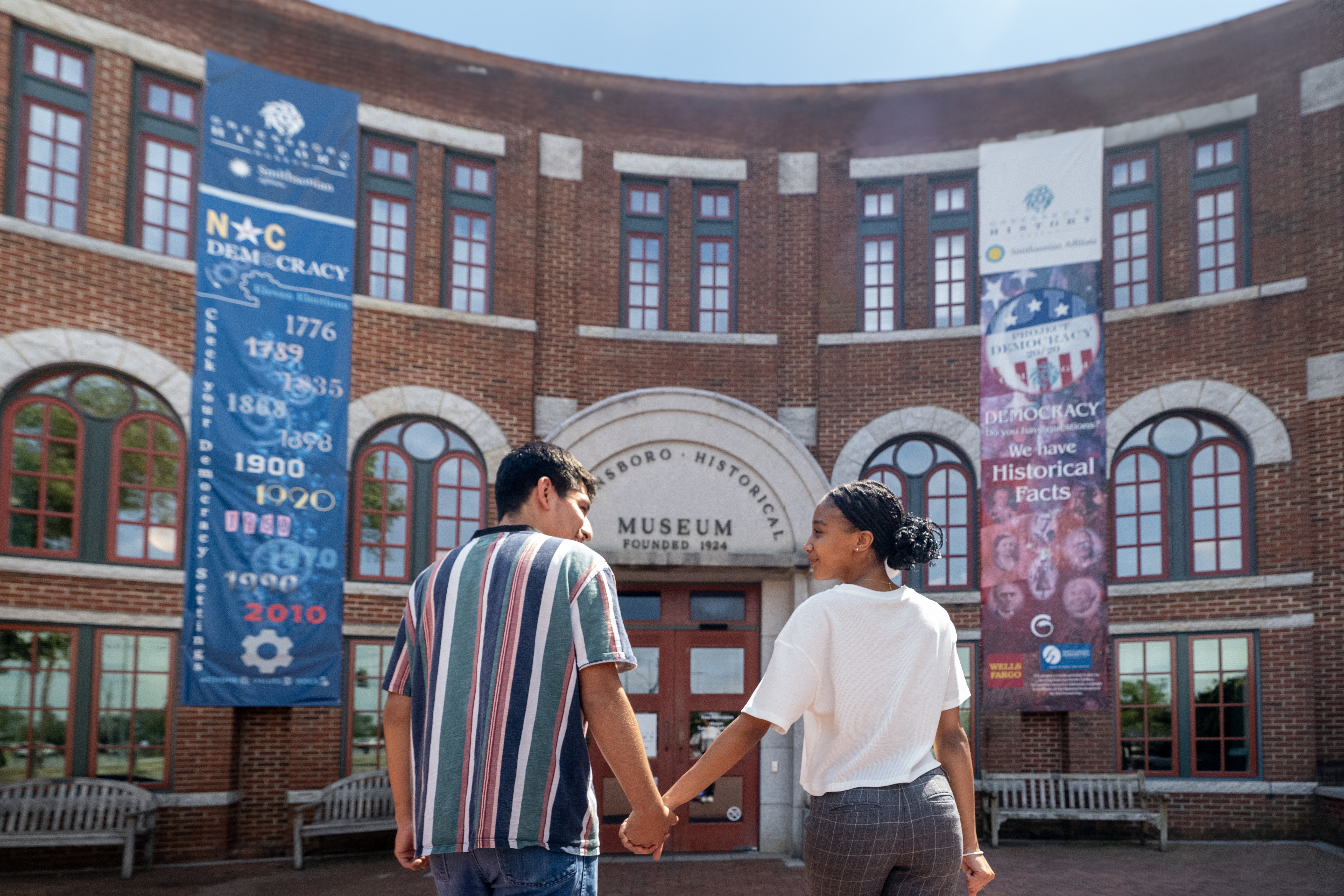 Two people walking into the museum