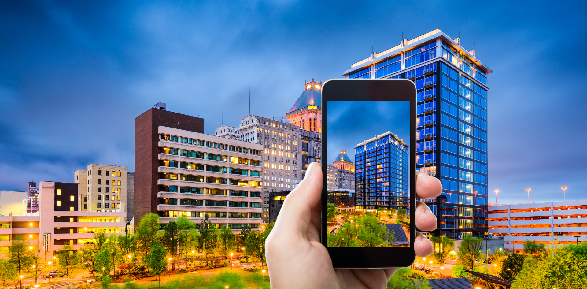 Downtown Skyline with hand holding cellphone