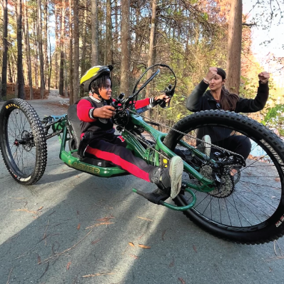 Person learning to ride adaptive mountain bike